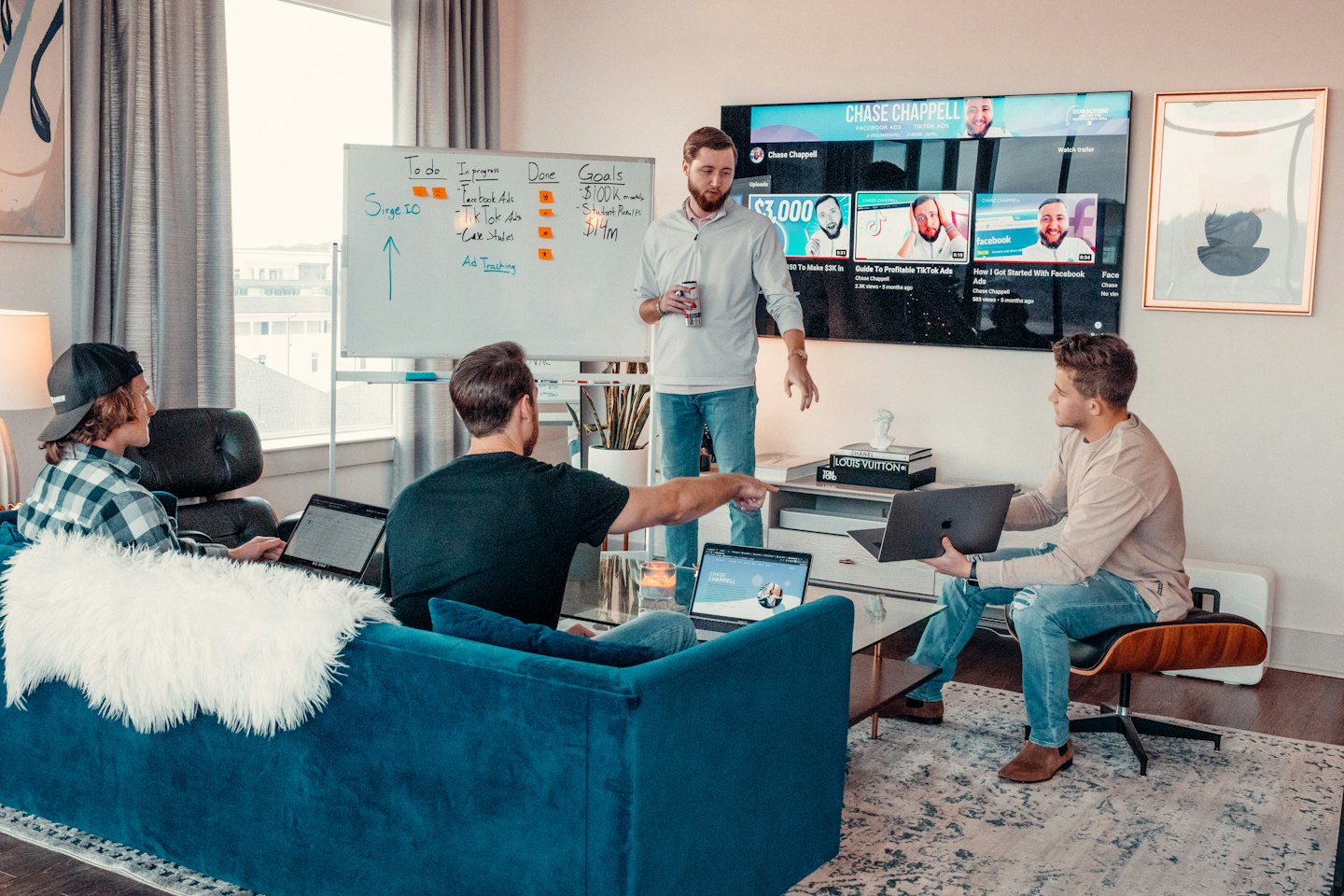 Men collaborating on a business idea around a whiteboard.